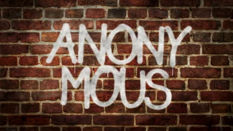 Anonymous spray painted on the brick wall Stock Footage 154100163