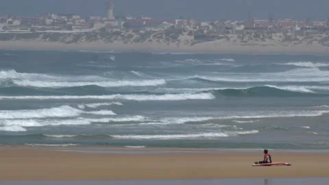 Anonymous Surfer Sitting on Atlantic Ocean Coast Sandy Beach in Portugal Stock Footage 248603491