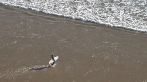 Anonymous Surfer walking on Atlantic Ocean Coast Sandy Beach in Morocco Stock Footage 180522746