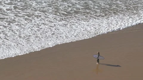Anonymous Surfer walking on Atlantic Ocean Coast Sandy Beach in Morocco Stock Footage 180522868