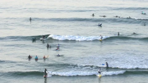Anonymous Surfers Surfing Small Waves on Atlantic Ocean in Morocco Stock Footage 229781196