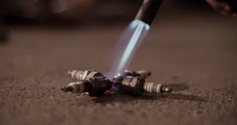 Anonymous technician using blowtorch on spark plugs Stock Footage 221106844