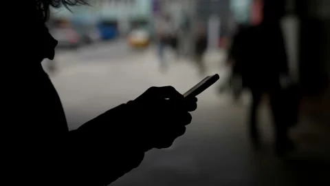 Anonymous user of social nets, dark silhouette of person with smartphone in Video stock 154862741