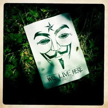 Anonymous "We Live Here" Propaganda Flyer on the Ground Stock Photos