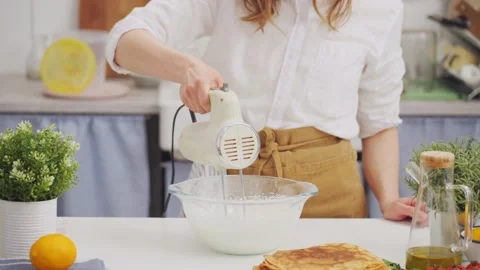 Anonymous woman chef using a mixer whipping a batter Stock Footage 168601586