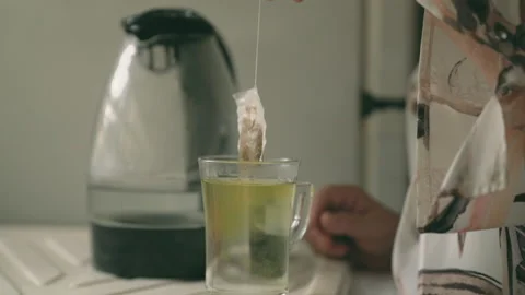 Anonymous woman making tea with tea bag Stock Footage