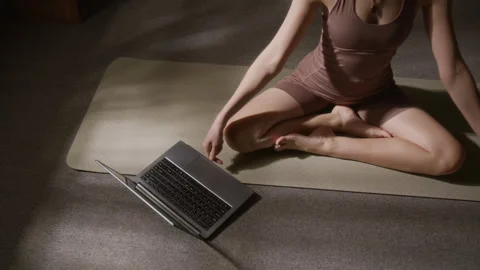 Anonymous Woman Sitting in Lotus Pose and Playing Meditation Guide on Laptop Stock Footage 329741553
