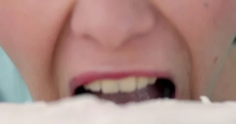 Anonymous woman taking bite of cake Stock Footage 122322787