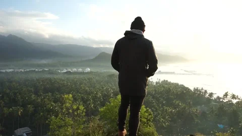 Another person standing on the hill looking at the view Stock Footage 271115265