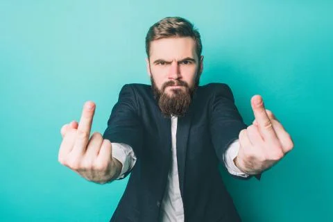 Another picture of angry man is standing and shwoing bad symbols with fingers on Stock Photos