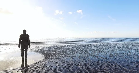 "Another Place" - Human Statue Looking Out Over the Ocean on England Shoreline Video stock 89355099