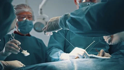 Another surgery. Close up view of the medical team performing an surgical Stock Footage 144852477