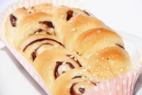 Anpan round bread with azuki red beans paste closeup isolated on plate on whi Stock Photos