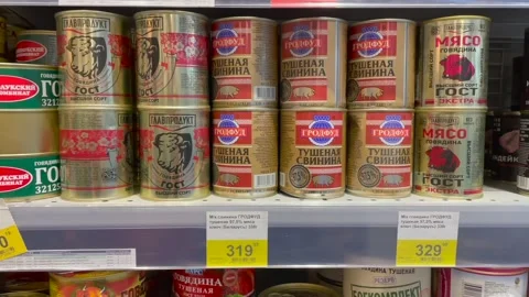 Ans of beef, pork and turkey stew at the grocery store. Rising food prices. Stock Footage 201859223