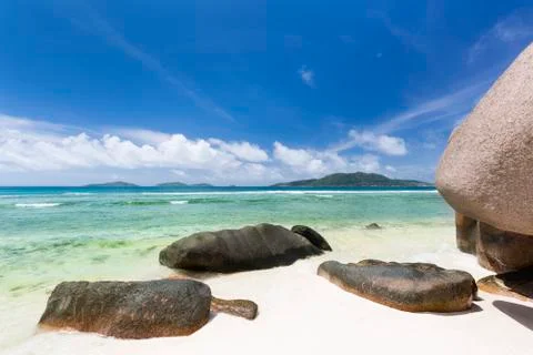 Anse Grosse Roche in La Digue, Seychelles with clear water and granite rocks Stock Photos