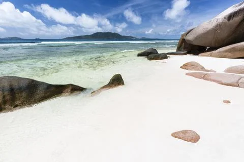 Anse Grosse Roche in La Digue, Seychelles with clear water and granite rocks Stock Photos