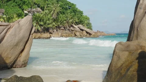 Anse Patates beach on La Digue island features tropical sand, boulders Видео 331505782