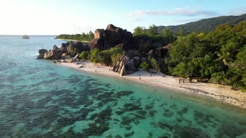 Anse Source d'Argent paradise beach in the Seychelles. Aerial view at sunset Stock Footage 341547744