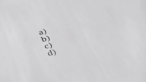 Answer C. Blue marker writing answer on paper answer of question in examination Vídeos de archivo 118699444