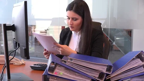 Answer office phone call busy accountant executive with stack of paperwork files Stock Footage 82312533