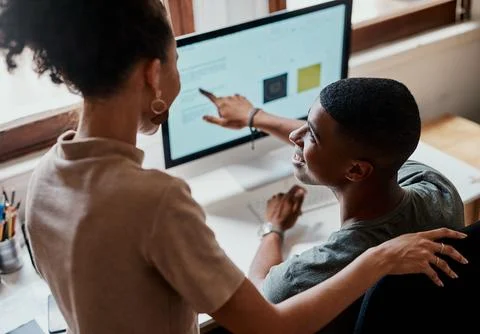 The answer is right in front of you. a young businessman and businesswoman using Stock Photos