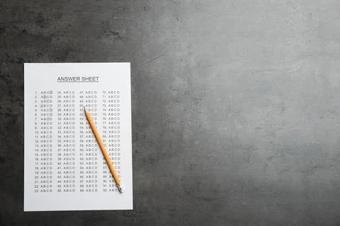 Answer sheet and pencil on grey background, top view with space for text 写真素材