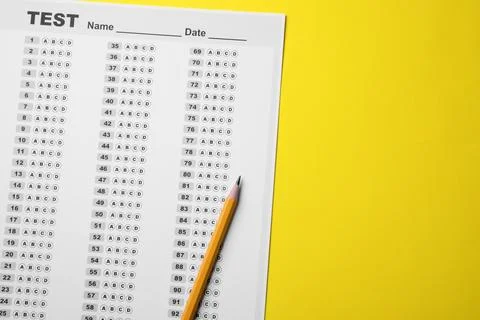 Answer sheet and pencil on yellow background, flat lay with space for text... 写真素材