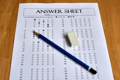 Answer Sheet With Filled Response Bubbles and Pencil Placed on Wooden Table.. Stock Photos