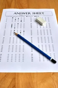 Answer Sheet Prepared for an Exam With a Blue Pencil and Eraser on a Wooden.. Stock Photos