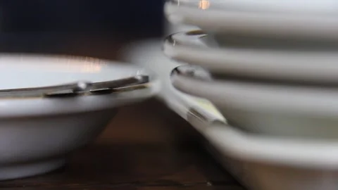 Ant Crawling Between Stacked White Plates on Wooden Table Stock Footage 331931374
