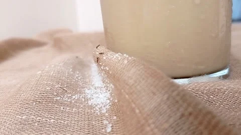 An ant with a ton of sugar on a brown table Stock Footage 146251287