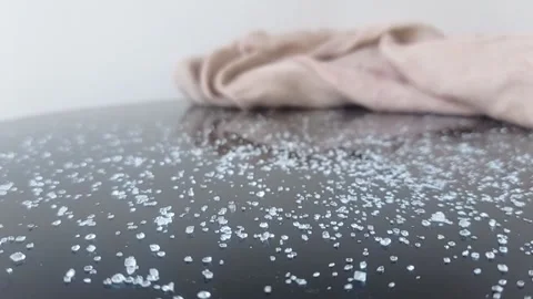 An ant with a ton of sugar on a brown table Stock Footage 146255286