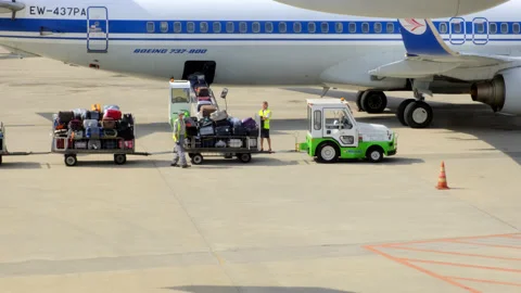 Antalya turkey - CIRCA 2021: Two workers at airport load their luggage onto Stock Footage 165249486