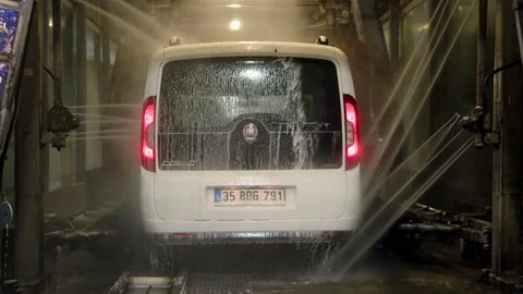 Antalya, Turkey - CIRCA 2023: Automatic car wash at night. white Fiat Doblo car Stock Footage 229400207