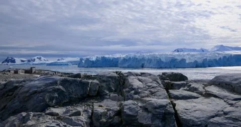 Antarctic base e before glacier front with stone beach landscape in Antarctica Stock Photos