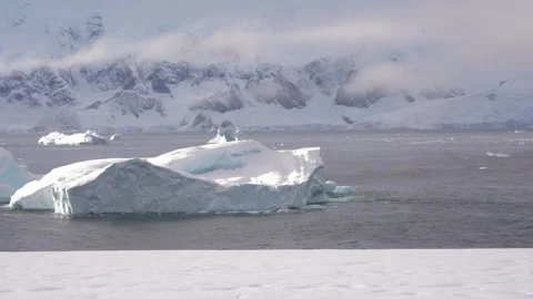 Antarctic expedition.  Icebergs float in the ocean near Antarctica Stock Footage 333246301