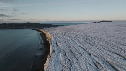 Antarctic glacier flowing toward calm coastal waters drone view Stockbeeldmateriaal 343123589