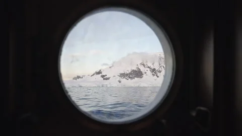 Antarctic Landscape Framed by Round Ship Porthole Stock-Footage 335997827