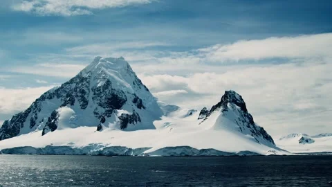 Antarctic landscape. The scene features a vast, snow-covered mountain. Stock Footage 297844295