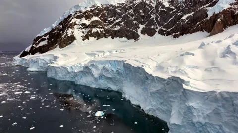 Antarctic landscape. The scene features a vast, snow-covered mountain. Stock Footage 297851439