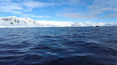 Antarctic Ocean View with Distant Zodiac Boat and Snowy Mountains Stock Footage 340466438