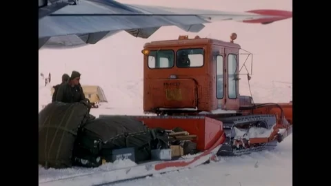 ANTARCTICA - 1956 - A D4 tractor reverses toward a snow sled loaded with Stock Footage 316680532