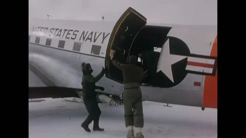 ANTARCTICA - 1956 - Man putting an object into plane, jumps aboard pulling the Video stock 316681744