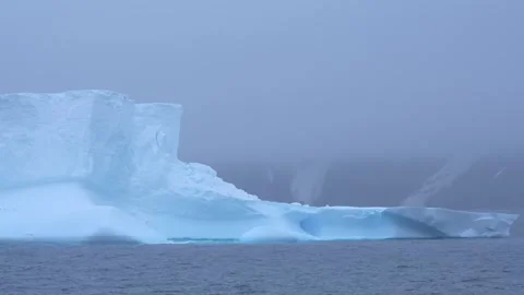 Antarctica Close Up Massive Blue Iceberg Floats in Frozen Ocean Waters. Wav.. Stock Footage 340303287