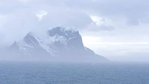 Antarctica Dramatic Mountain Covered in Mist and Clouds Close Up with Blow .. Vídeo Stock 340590792