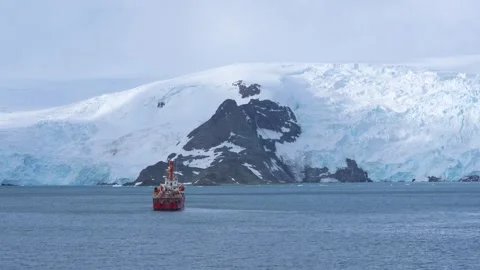 Antarctica Red Science Research Vessel Ship Wide Shot in Ocean Glacier Whit.. Stock Footage 340591555