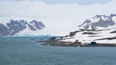 Antarctica Sailing By Science Base Rocky Coastline Ice on Shore Mountains Stock Footage 277919488