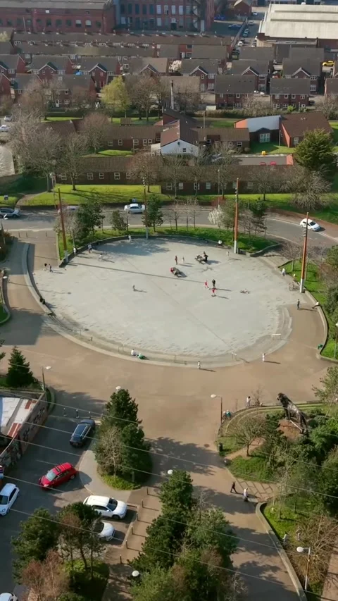 Anti-clockwise 60FPS vertical social ratio aerial video of C.S. Lewis Square in Stock Footage 332890776