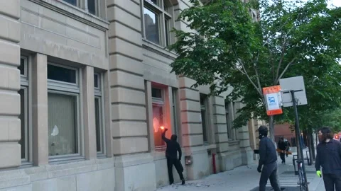 Anti-fa trying to put fire in building Stock Footage 132484124