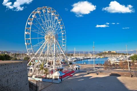 Antibes, France. Giant ferris wheel and yachting harbor view in town of Antib Stock Photos